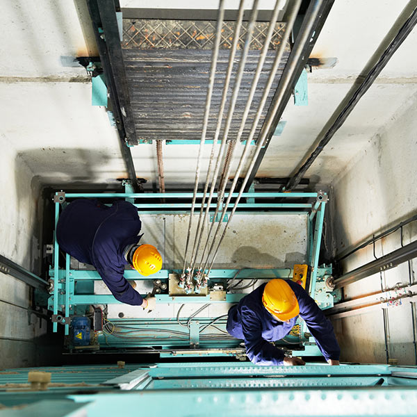 Machinist with spanner adjusting lift mechanism